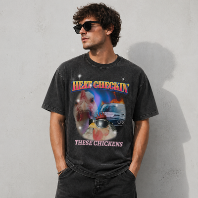 Male model wearing Heat Checkin' These Chickens oversized graphic tee in black by THE 199X
